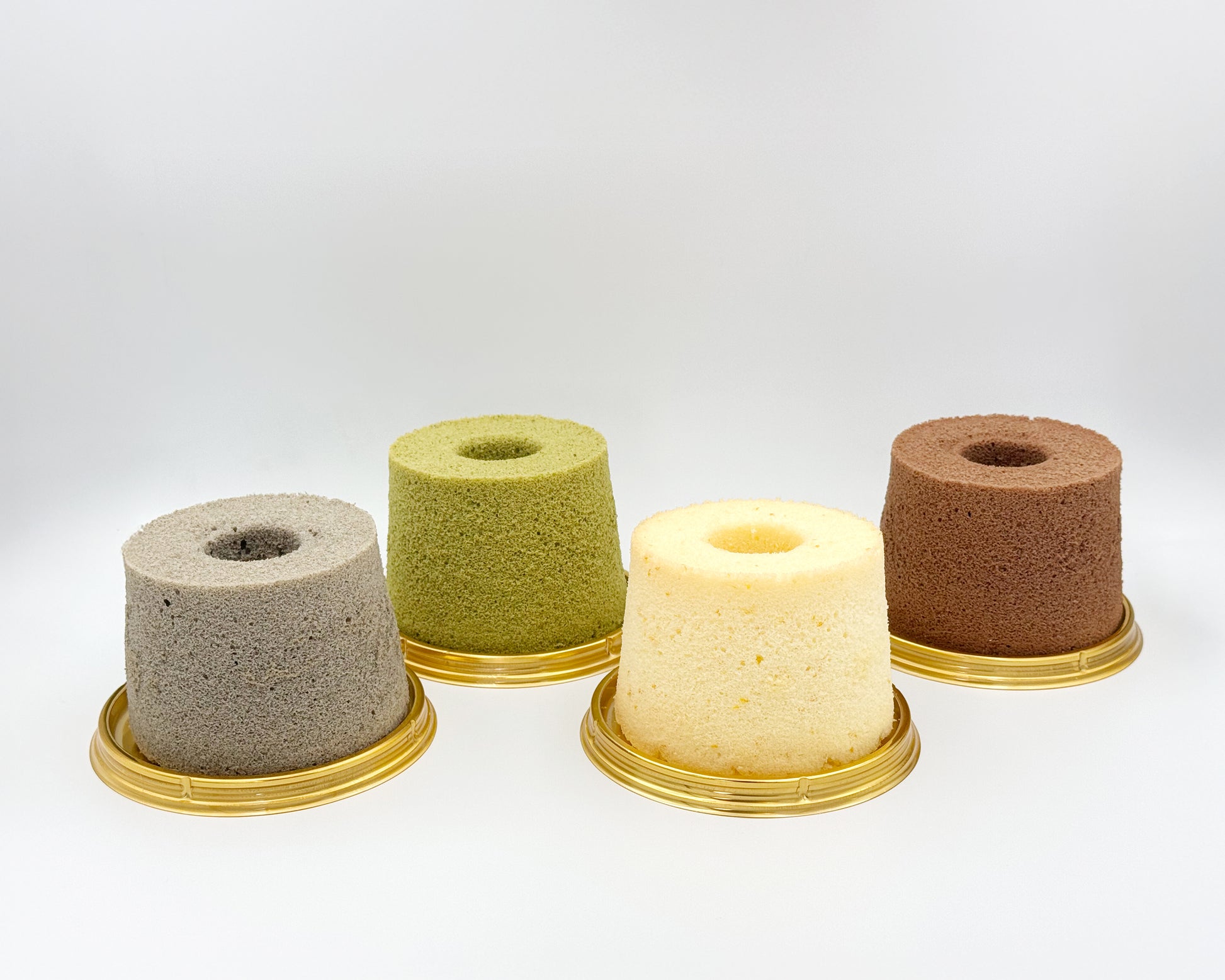 Four small chiffon cakes flavour on a white background