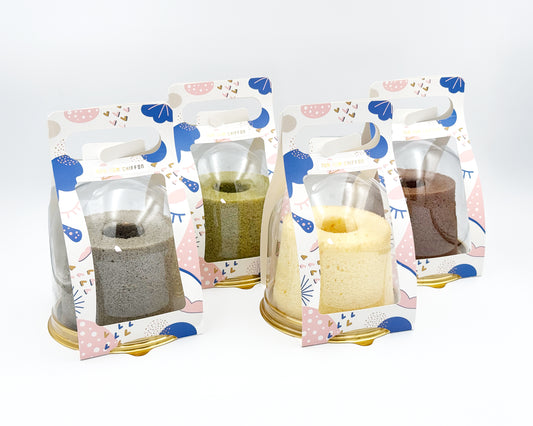 Four small chiffon cakes flavour in decorative packaging with a white background