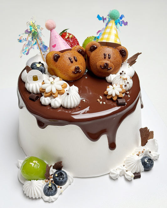Decorative cake with teddy bear figures and chocolate ganache on a white background