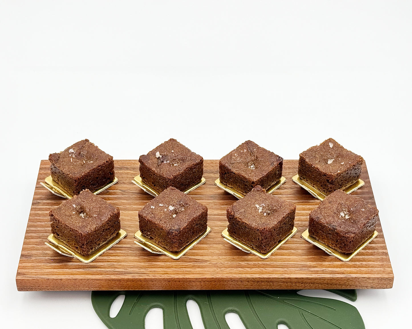 Brownies on a wooden board with a white background