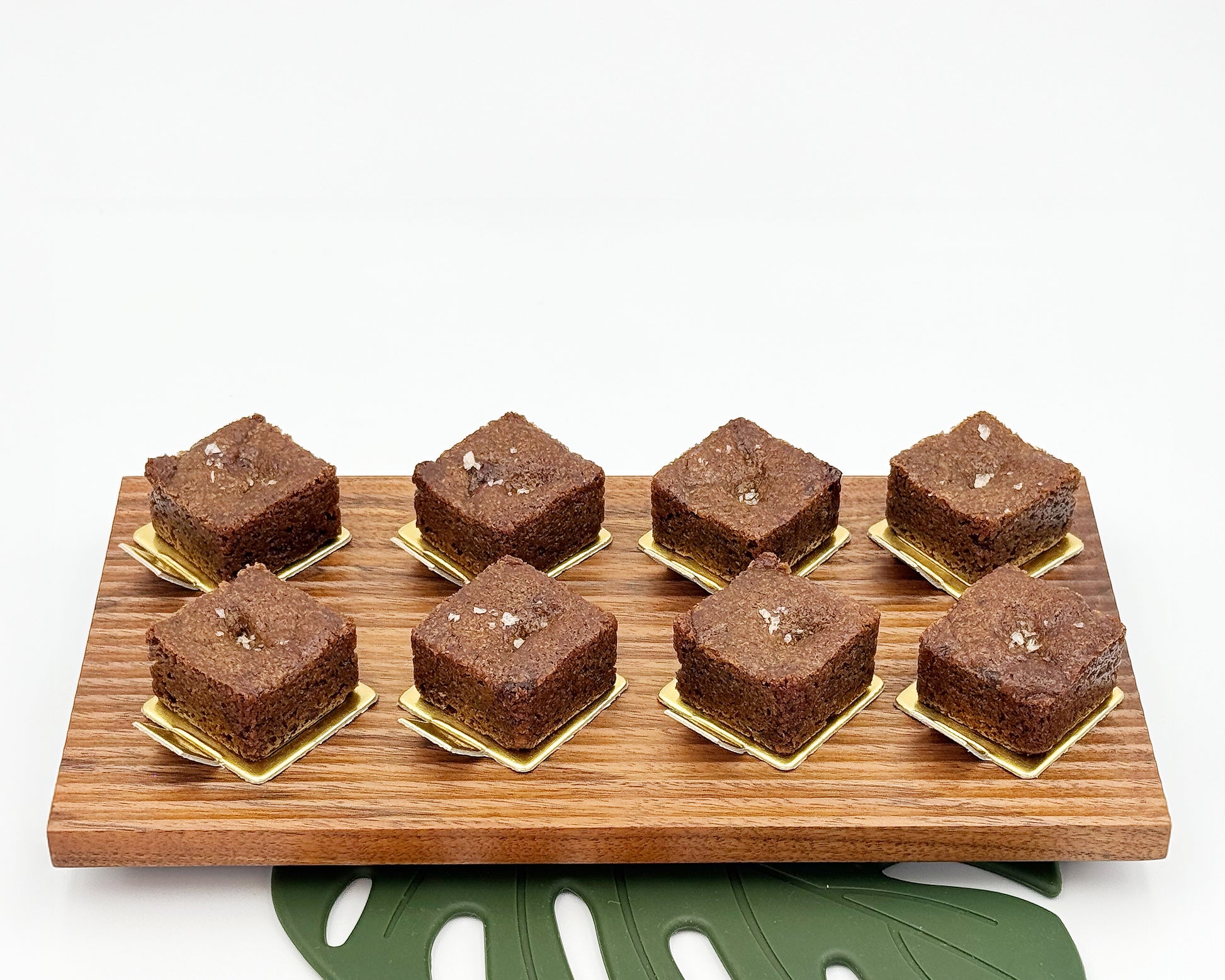 Brownies on a wooden board with a white background