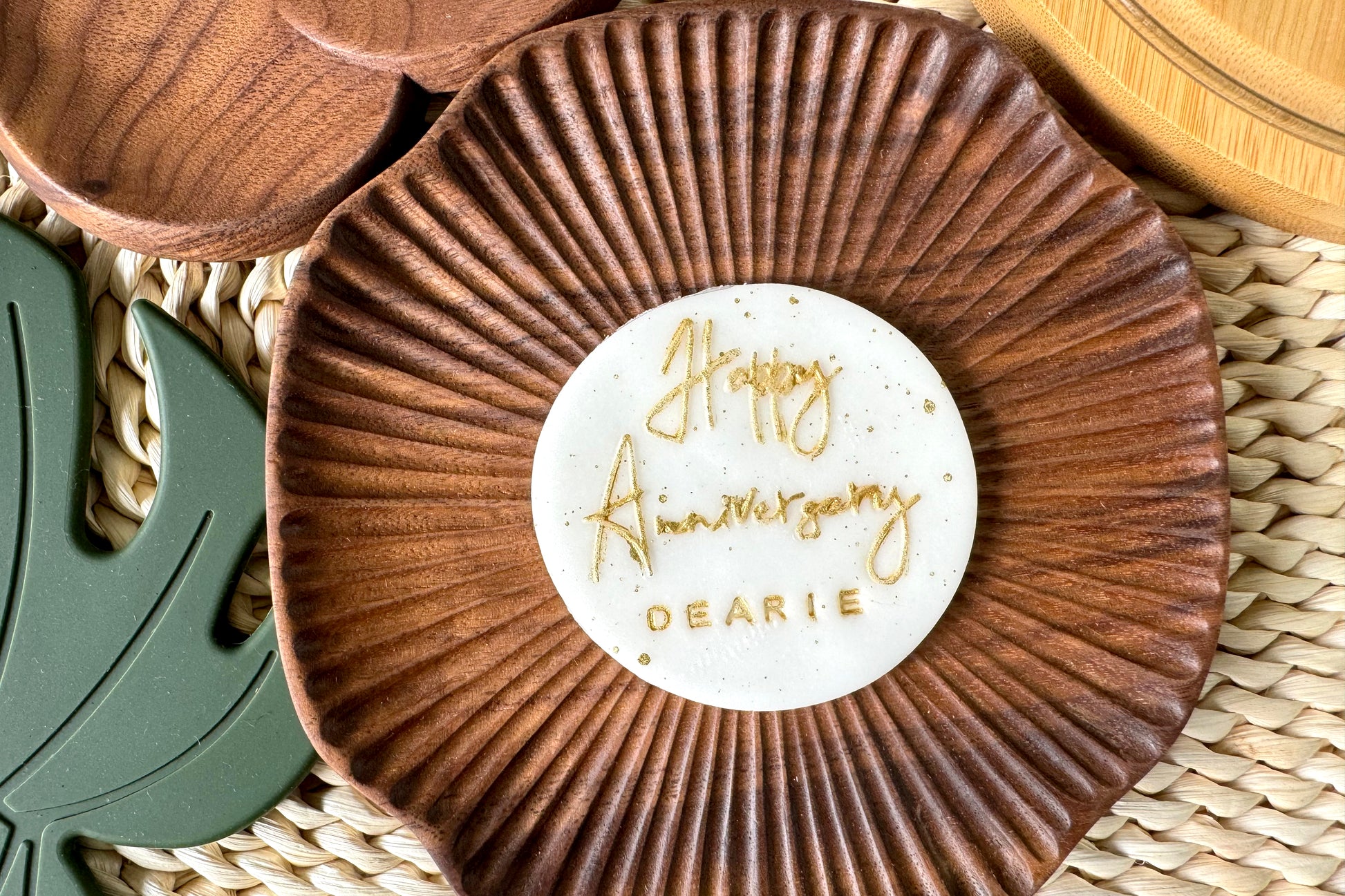 Wooden coaster with 'Happy Anniversary Dearie' message on a woven surface