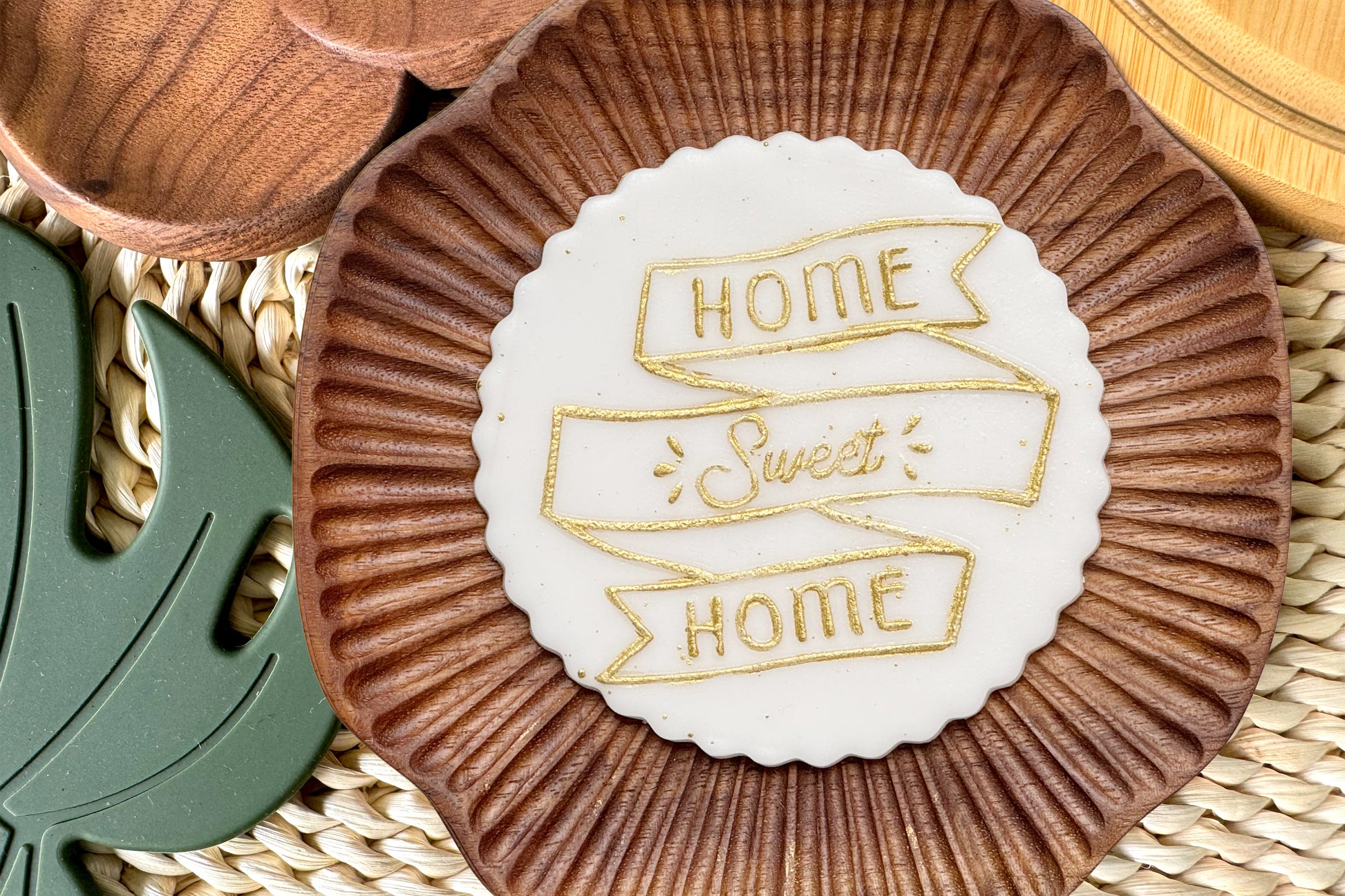 Decorative cake topper with 'Home Sweet Home' text on a woven surface