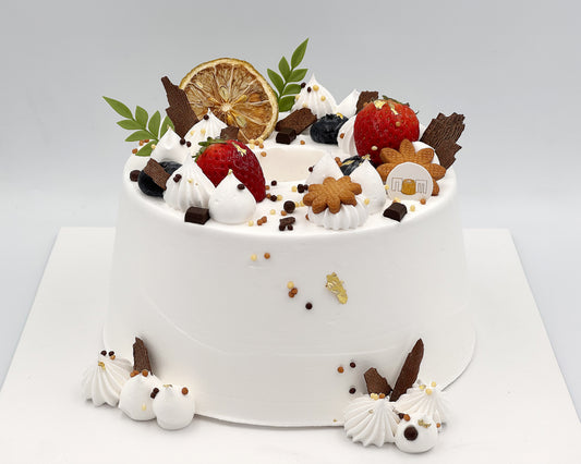 Decorative chiffon cake with various toppings on a white background
