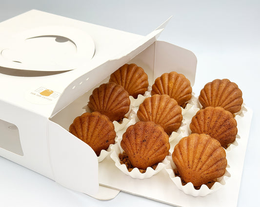 seashell madeleines in a white box on a light gray background