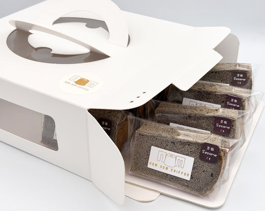 Black sesame chiffon cake in clear packaging with a white box on a light gray background