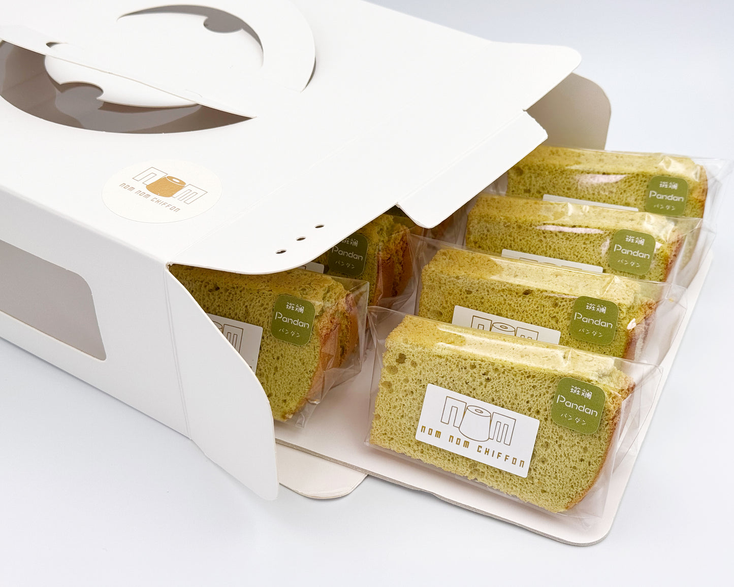 Packaged sliced pandan chiffon cakes in a white box on a light gray background
