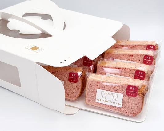 Packaged strawberry chiffon cake in a white display box on a light gray background