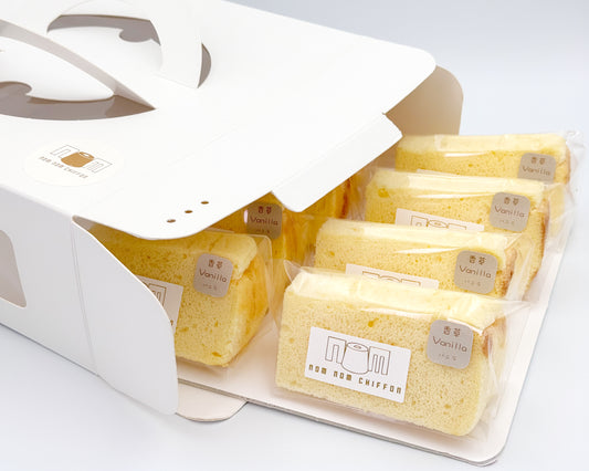 Packaged vanilla chiffon cake in a white box on a light gray background