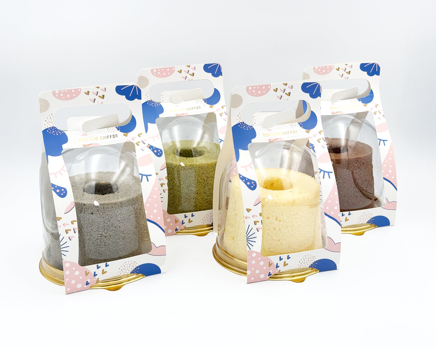 Four small chiffon cakes flavour in decorative packaging with a white background