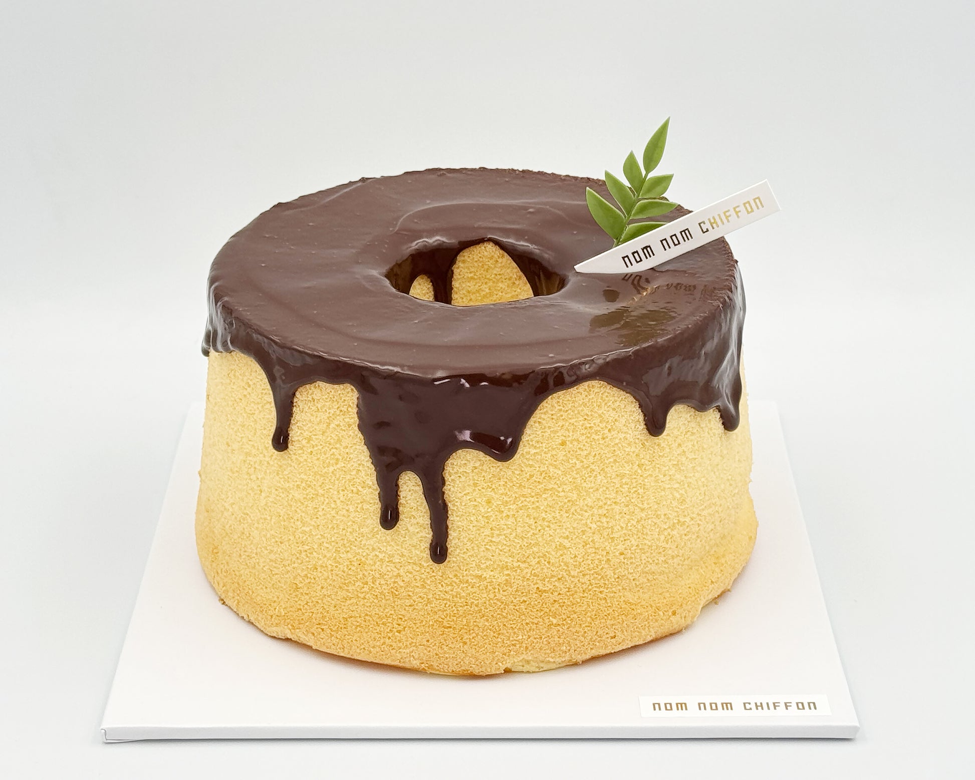 Naked orange zest chiffon cake topped with chocolate ganache, chocolate drip