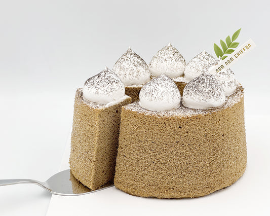 Earl grey chiffon cake with large dollops of cream, sliced