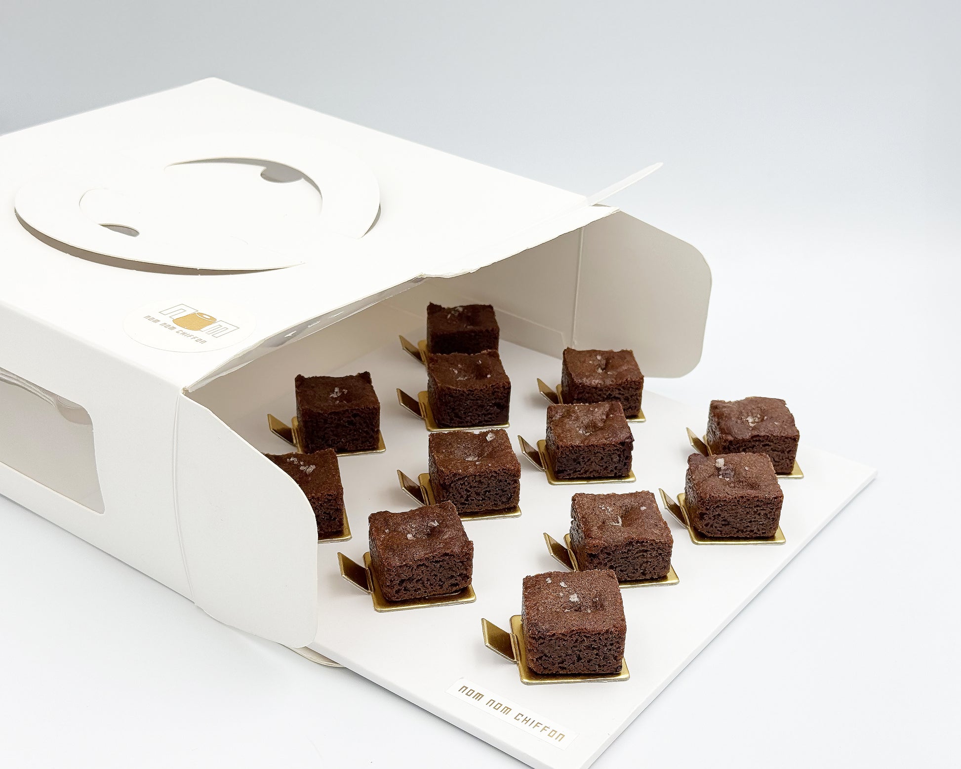 Brownies in a decorative box on a white background