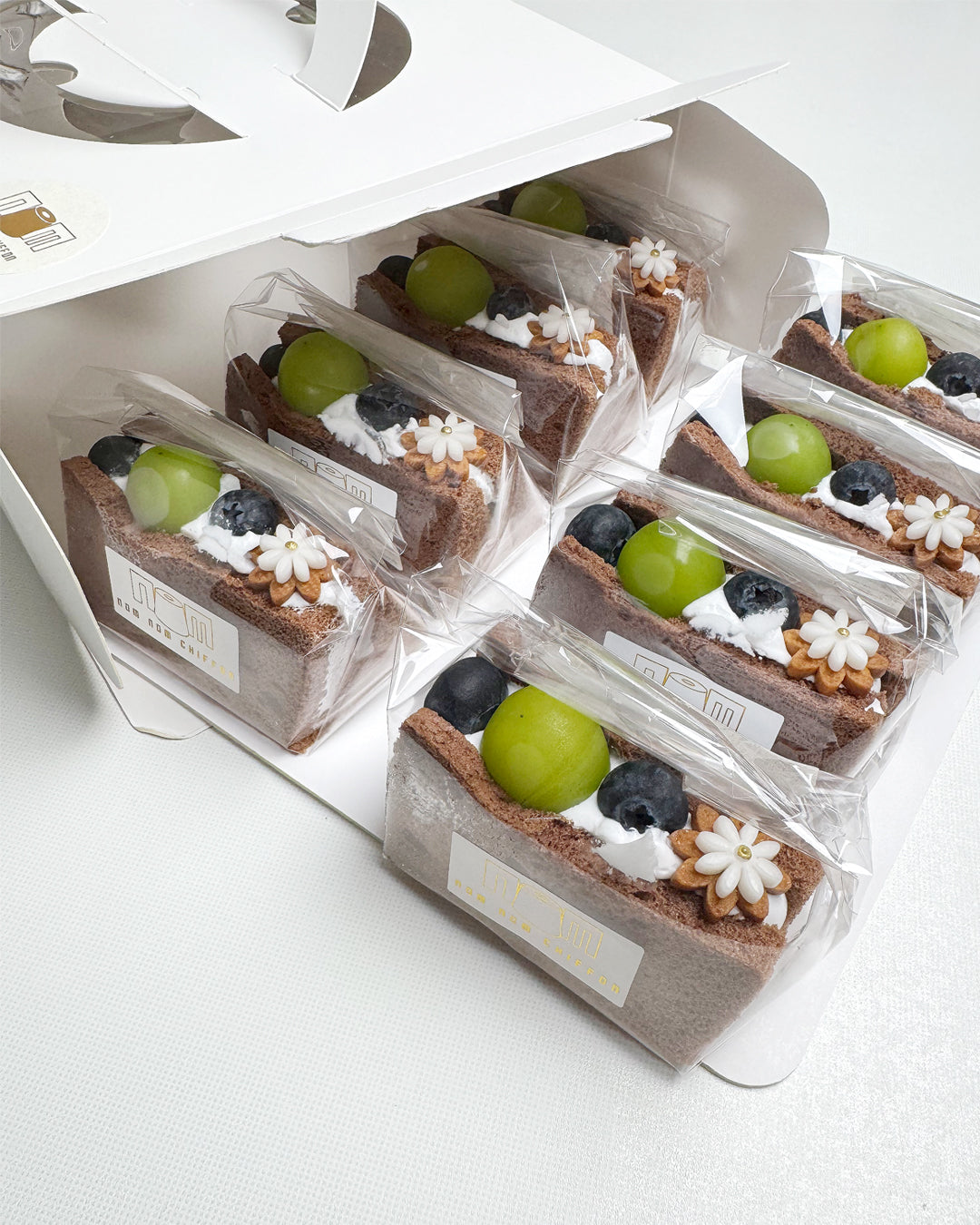 Packaged chocolate chiffon fruit sando on a white background