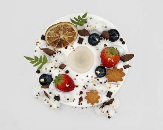 Top view, Decorative chiffon cake with fruits, cookies, and a hollow center, on a light gray background