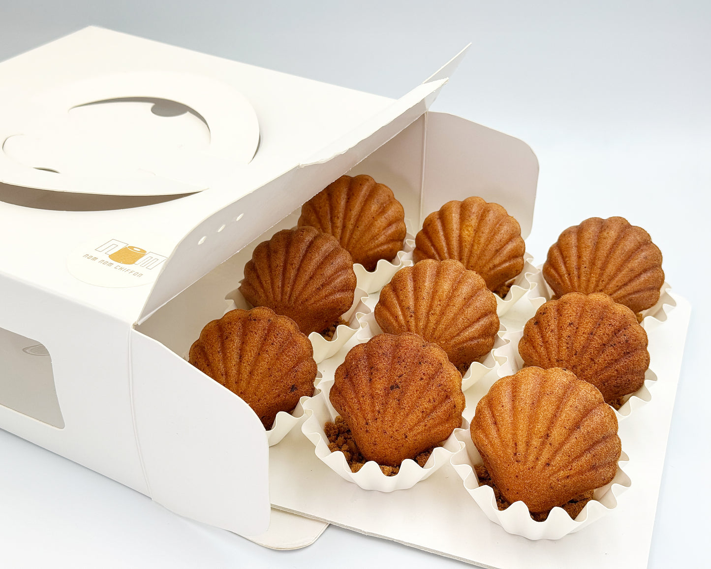 seashell madeleines in a white box on a light gray background